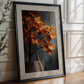 Framed artwork of a floral arrangement on a wooden floor with a vase of plants.