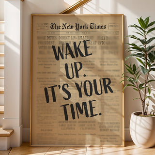 Framed New York Times article on a wall next to a staircase with a plant.