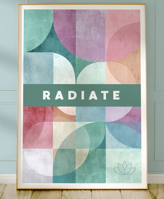 Colorful abstract art print with 'Radiate' text on a wall.