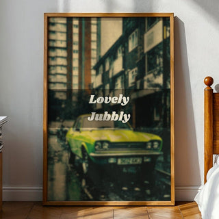 Framed artwork of a vintage car on a wall in a bedroom with sunlight streaming in.