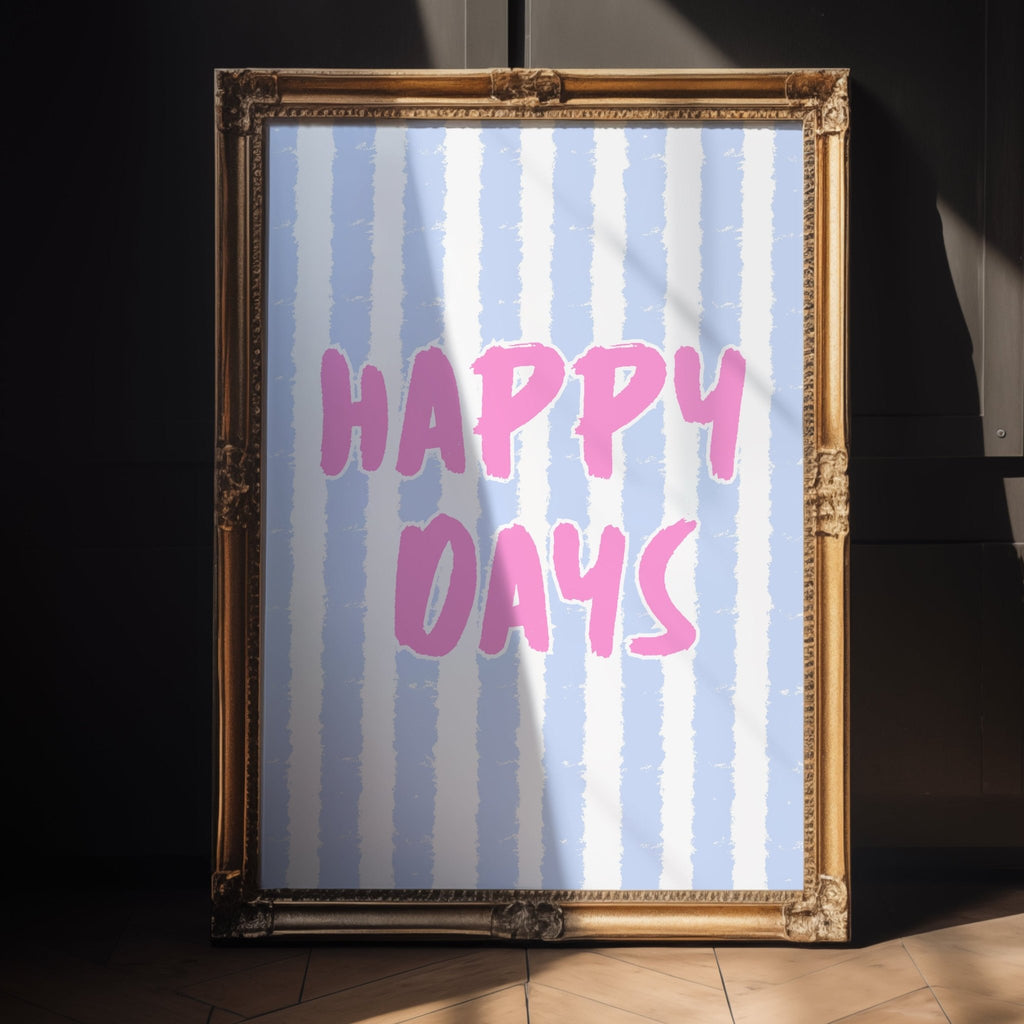 Framed artwork with 'Happy Days' text on a striped background, placed against a dark wall.
