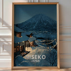 Illustrated 'Niseko Japan' poster of a snow-covered chalet strung with lights beneath a volcanic mountain at night