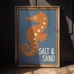 Framed artwork of a seahorse with 'Salt & Sand' text on a blue background

