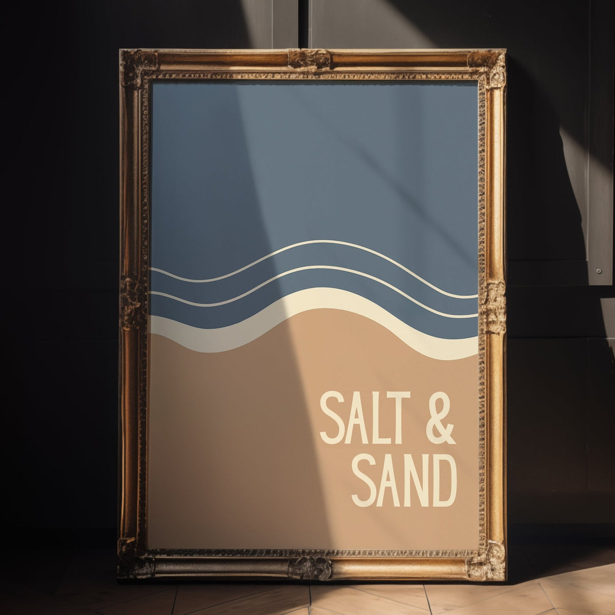 Framed poster with 'Salt & Sand' text and wave design on a wall.

