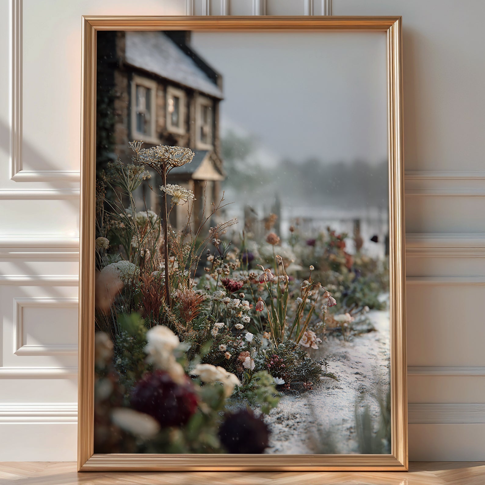 Close-up of frost-dusted winter wildflowers with a stone cottage in the background